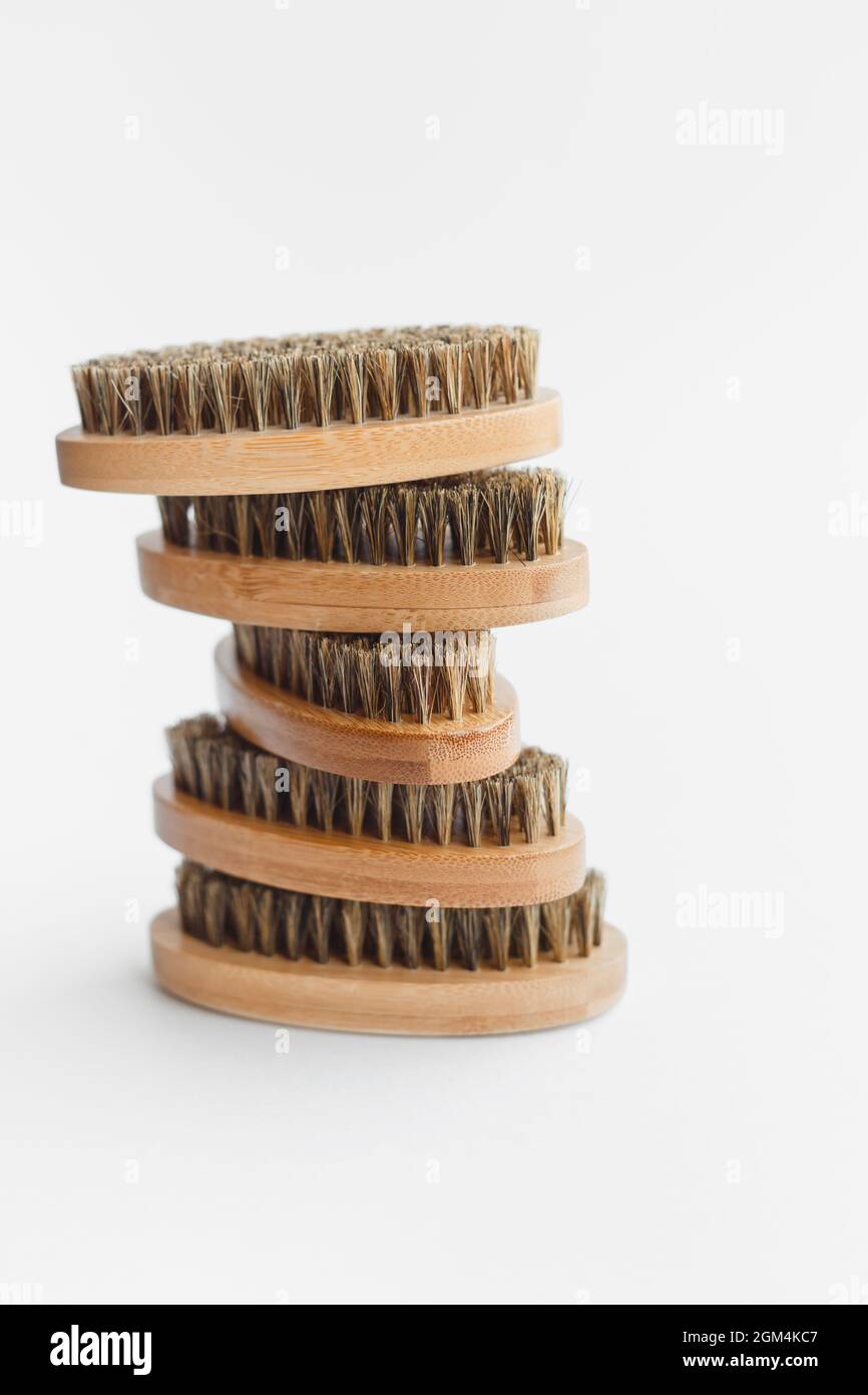 Stack of brown wooden beard brushes isolated on a white background ...