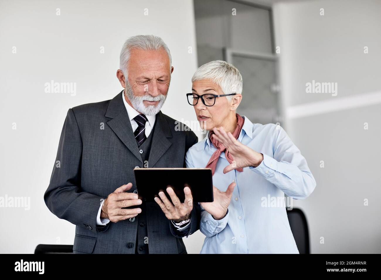 business office person discussion tablet teamwork senior meeting Stock Photo