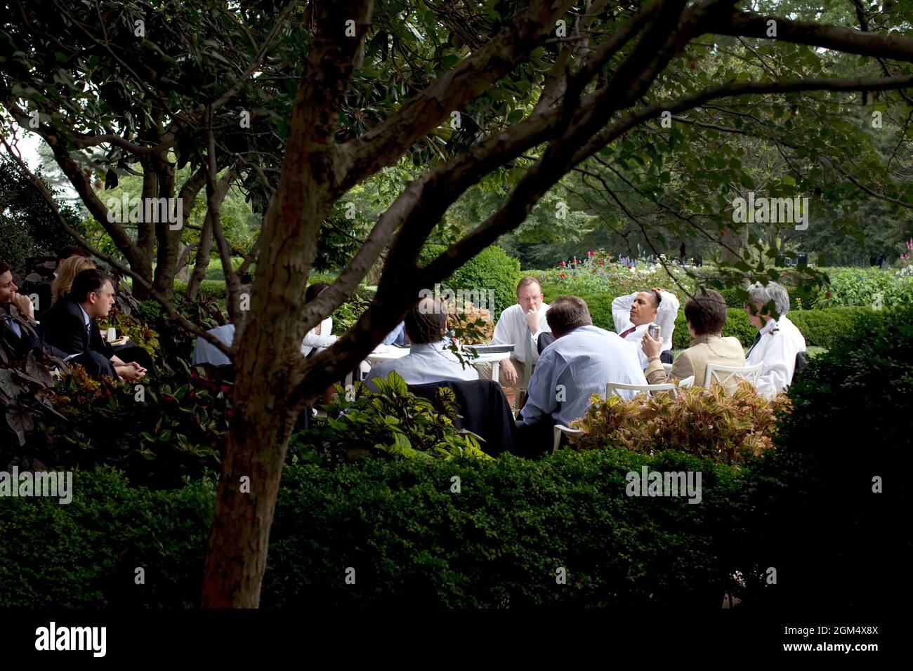 President Barack Obama and his senior advisors meet in the Rose Garden, taking advantage of a pleasant summer day in Washington,  August 12, 2009.  (Official White House photo by Pete Souza) This official White House photograph is being made available only for publication by news organizations and/or for personal use printing by the subject(s) of the photograph. The photograph may not be manipulated in any way and may not be used in commercial or political materials, advertisements, emails, products, promotions that in any way suggests approval or endorsement of the President, the First Family Stock Photo
