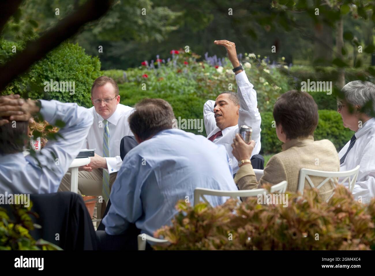 President Barack Obama and his senior advisors meet in the Rose Garden, taking advantage of a pleasant summer day in Washington,  August 12, 2009.  (Official White House photo by Pete Souza) This official White House photograph is being made available only for publication by news organizations and/or for personal use printing by the subject(s) of the photograph. The photograph may not be manipulated in any way and may not be used in commercial or political materials, advertisements, emails, products, promotions that in any way suggests approval or endorsement of the President, the First Family Stock Photo