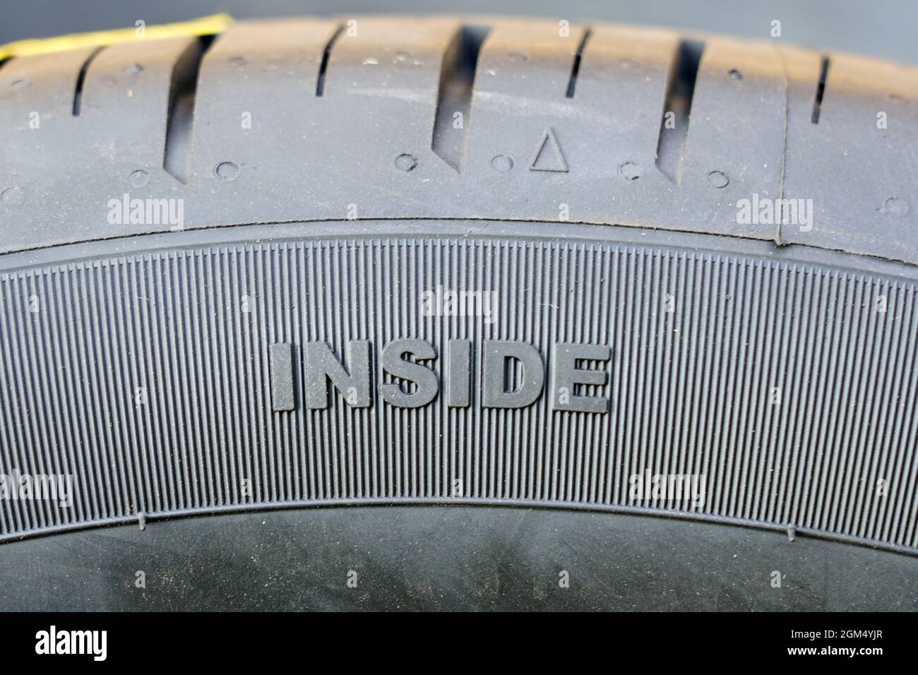 text on tire sidewall indicating direction for wearing the tires on the