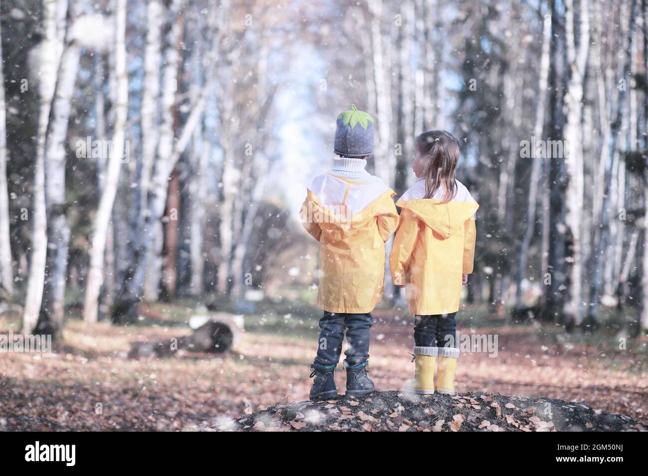 Kids walk in the park with first snow Stock Photo - Alamy