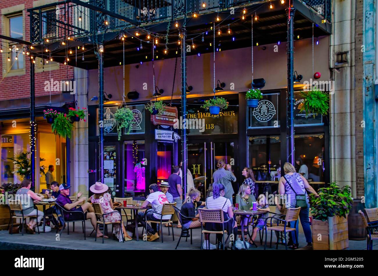 People eat on the sidewalk patio at The Haberdasher on Dauphin Street, Sept. 10, 2021, during Second Friday activities in Mobile, Alabama. Stock Photo