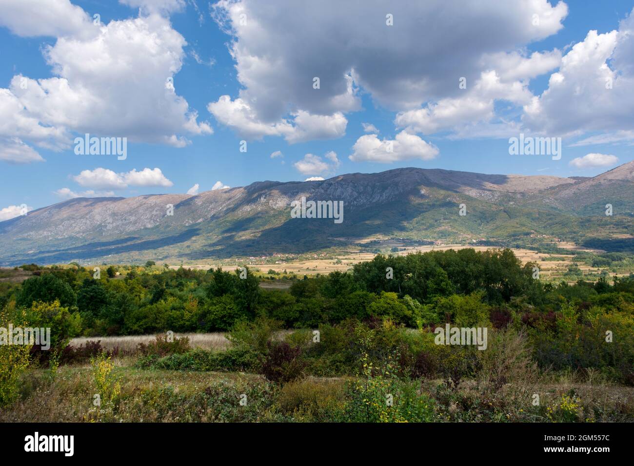 Beautiful landscape view of Suva Planina (The dry mountain) in Serbia on an autumn day. White clouds cast a shadow on the great mountain Stock Photo