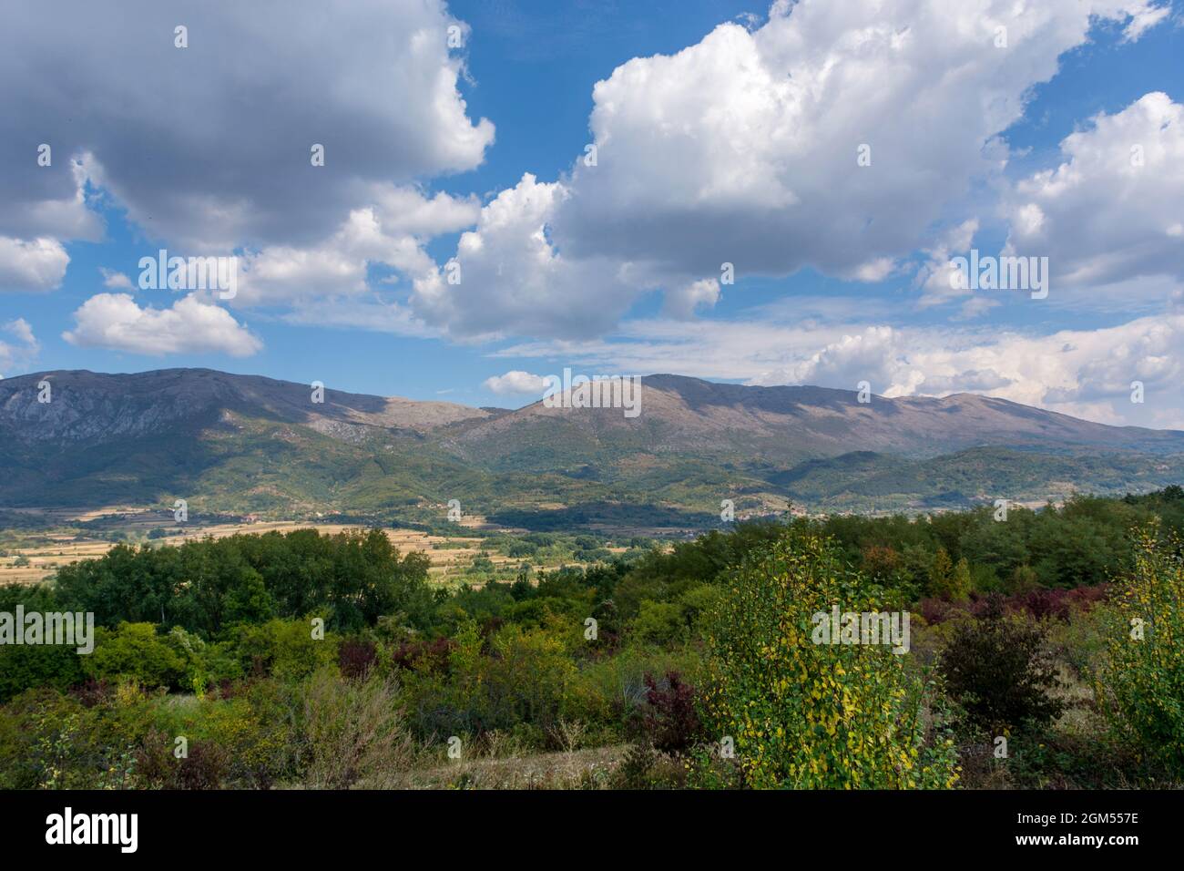 Landscape view of Suva Planina (The dry mountain) in Serbia on an autumn day. White clouds cast a shadow on the great mountain Stock Photo