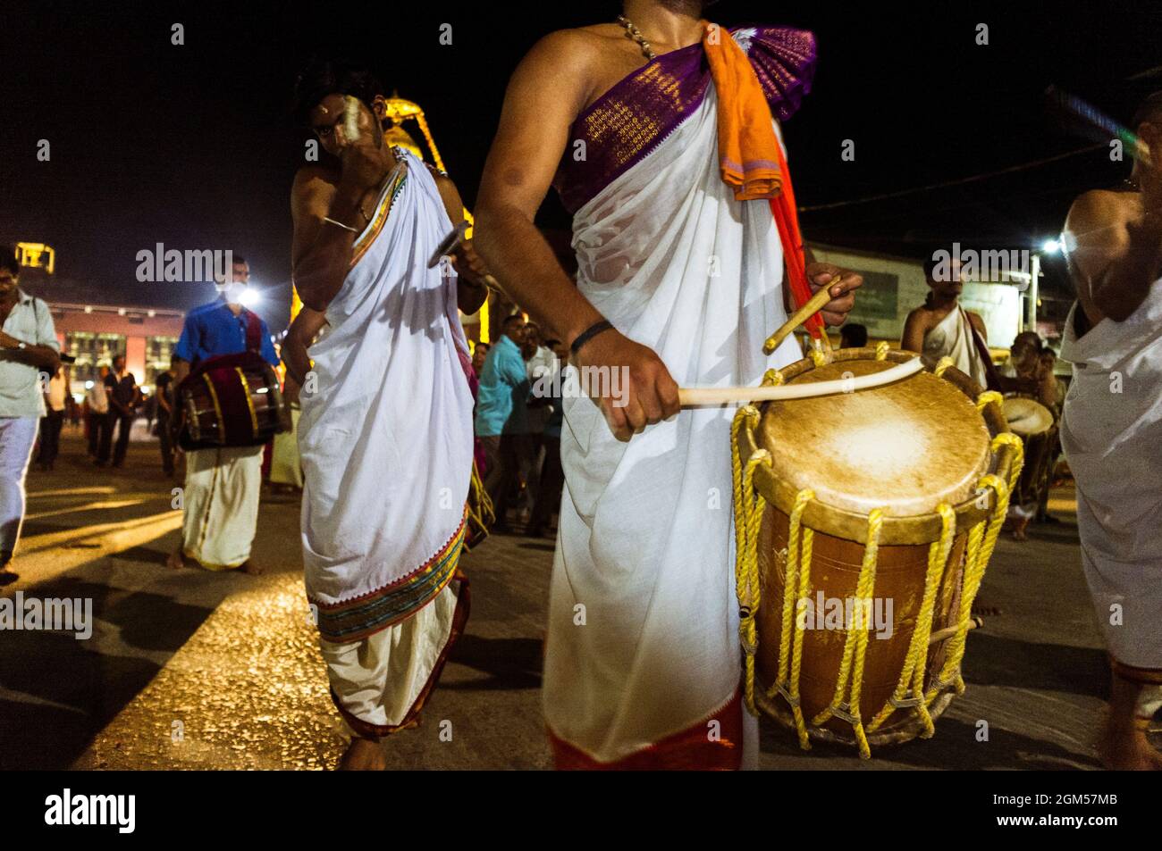 Udupi, Karnataka, India : A group of brahmin priests parade playing drums at night around  the 13th century Krishna temple. The temple was founded by Stock Photo