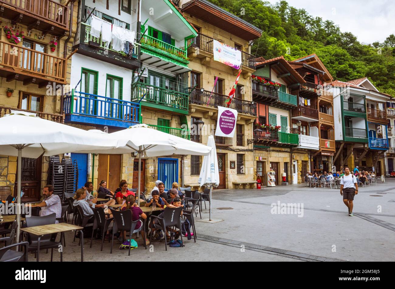 Pasajes, Gipuzkoa, Basque Country, Spain - July 17th, 2019 : Both locals and tourists sit alfresco at a tavern in the old town of Pasajes de San Juan. Stock Photo