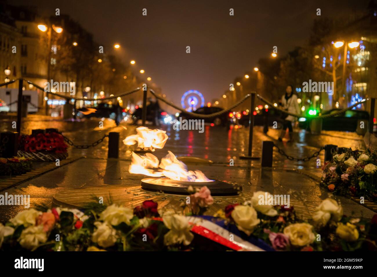 World famous Arc de Triomphe flowers and flame at the city center of Paris, France. Detail view from arc looking out to wheel Stock Photo