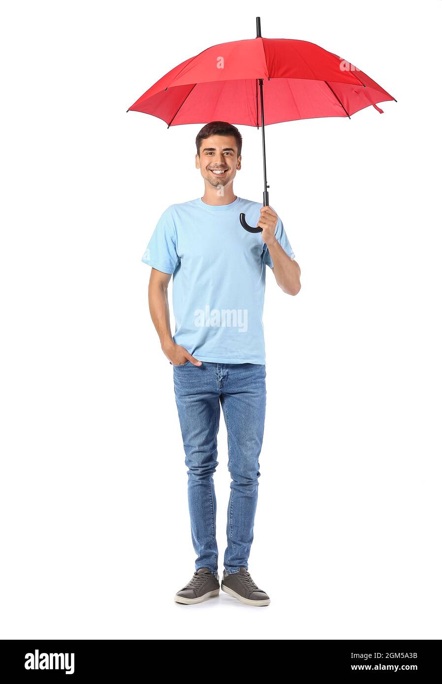 Handsome young man with umbrella on white background Stock Photo - Alamy