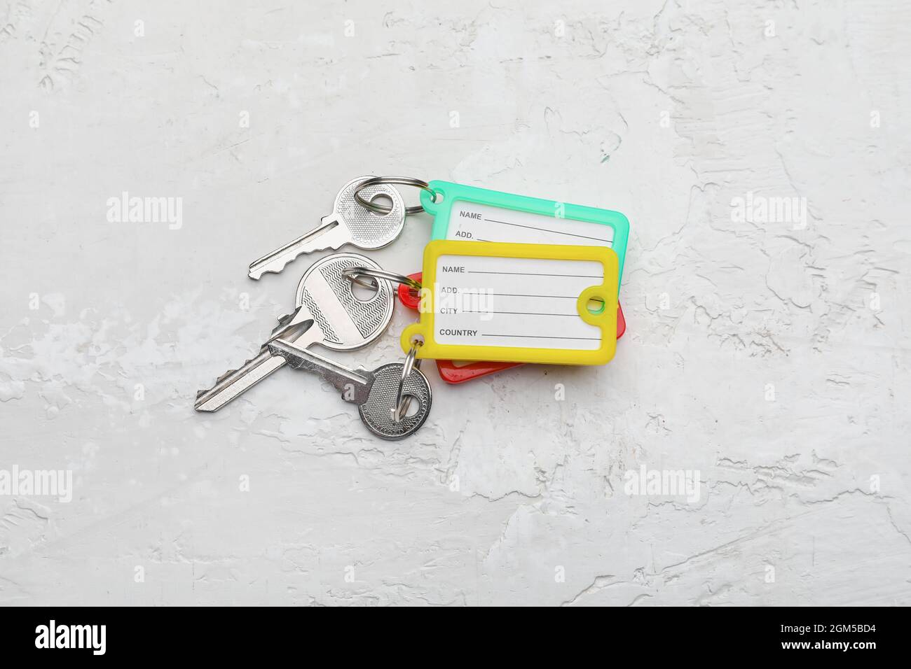Keys with plastic tags on light background Stock Photo