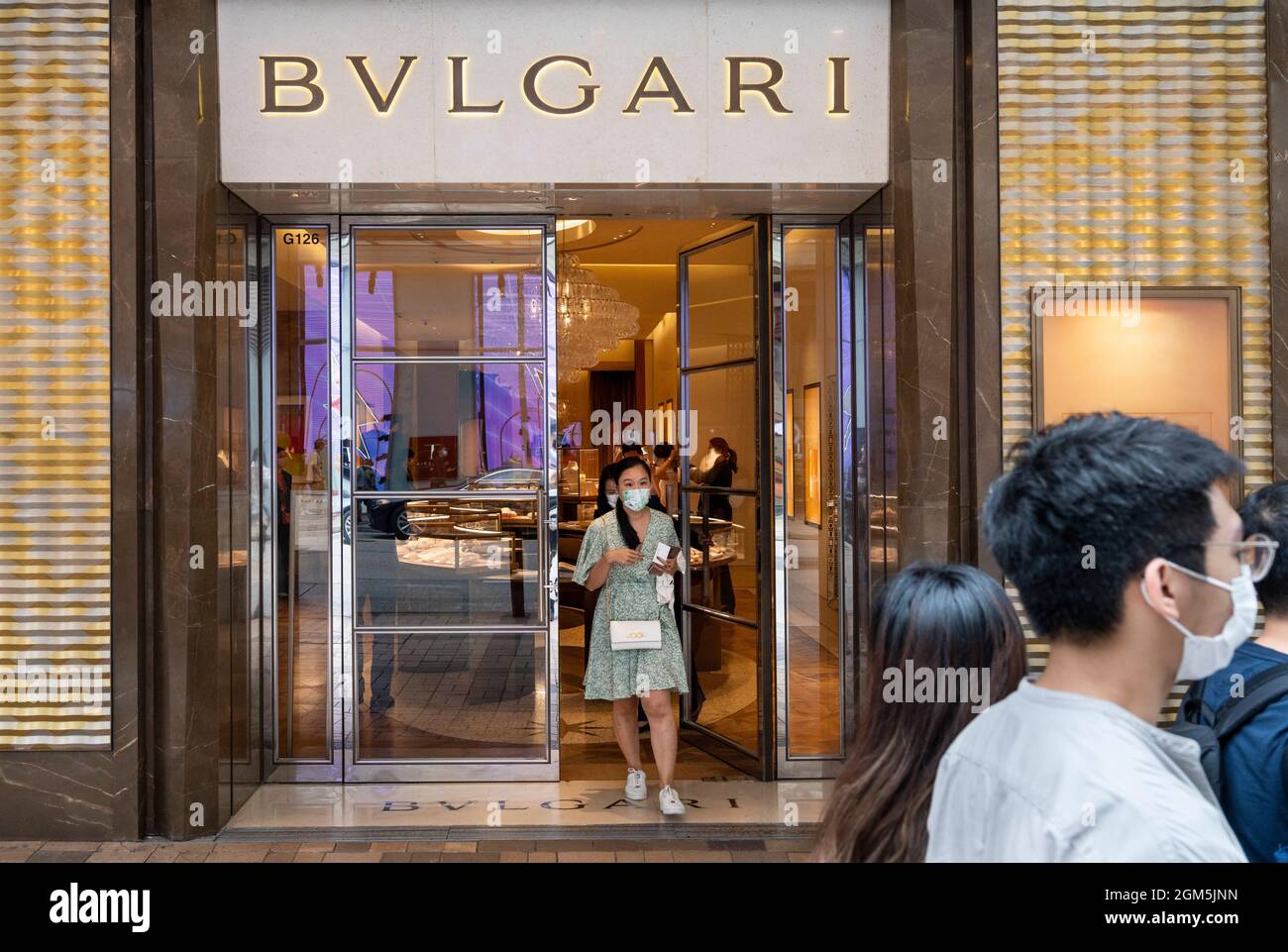A shopper exits the Italian luxury accessory brand store Bulgari in