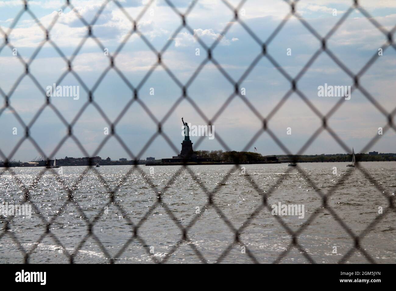 The freedom of Lady liberty behind the cage in New York City Stock Photo