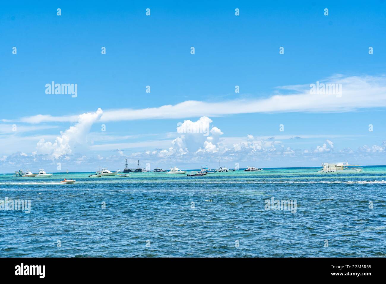 Beautiful Clouds with Tour Boats Over the Sea of Punta Cana. Stock Photo