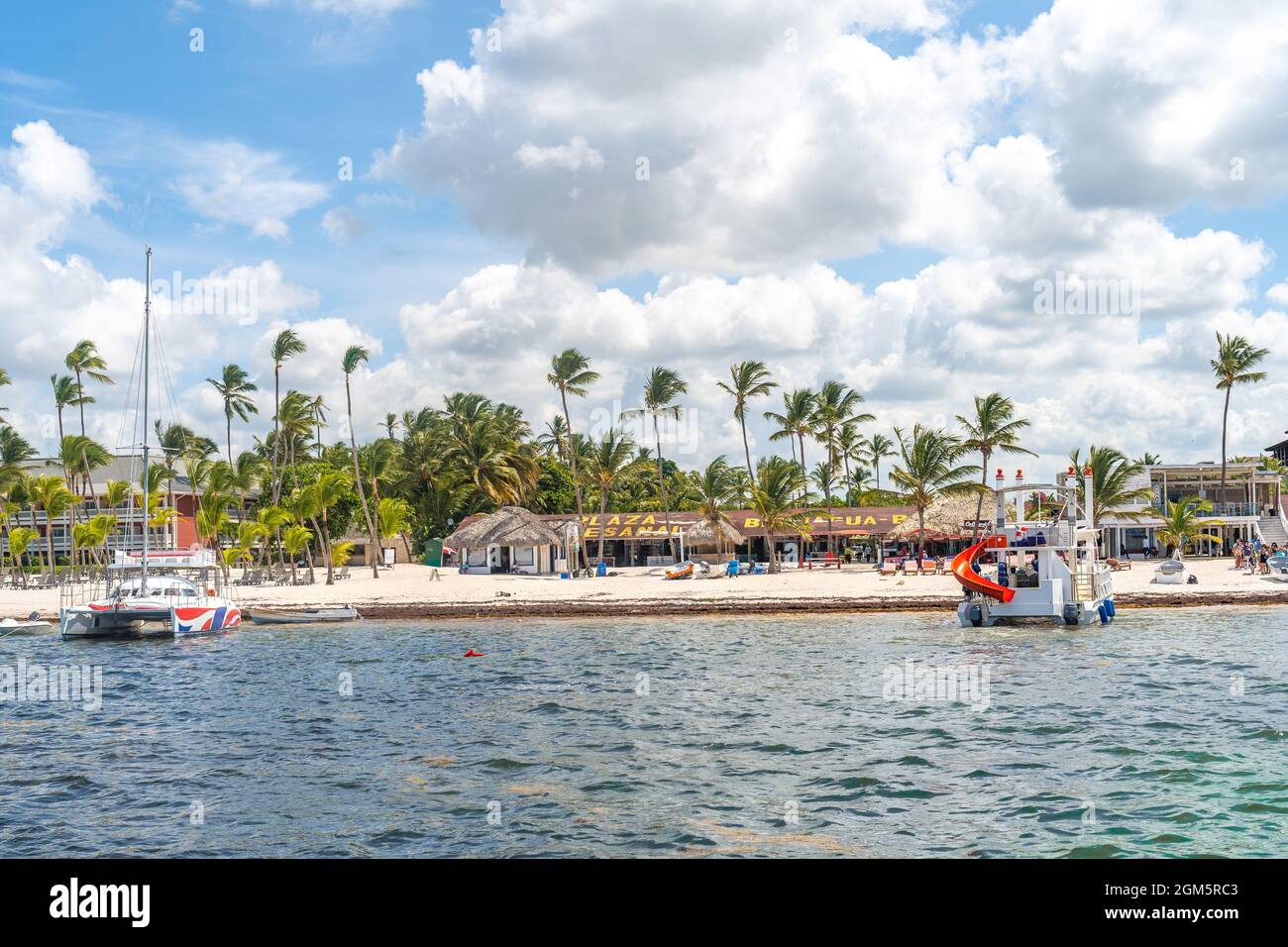 Dominican Beach Plaza with Palm Trees Water Boats and Beautiful White Sands. Stock Photo