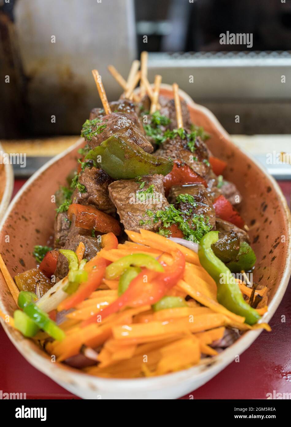 Tasty Beef Shish Kebab Garnished with Roasted Peppers and Served in a Bowl. Stock Photo