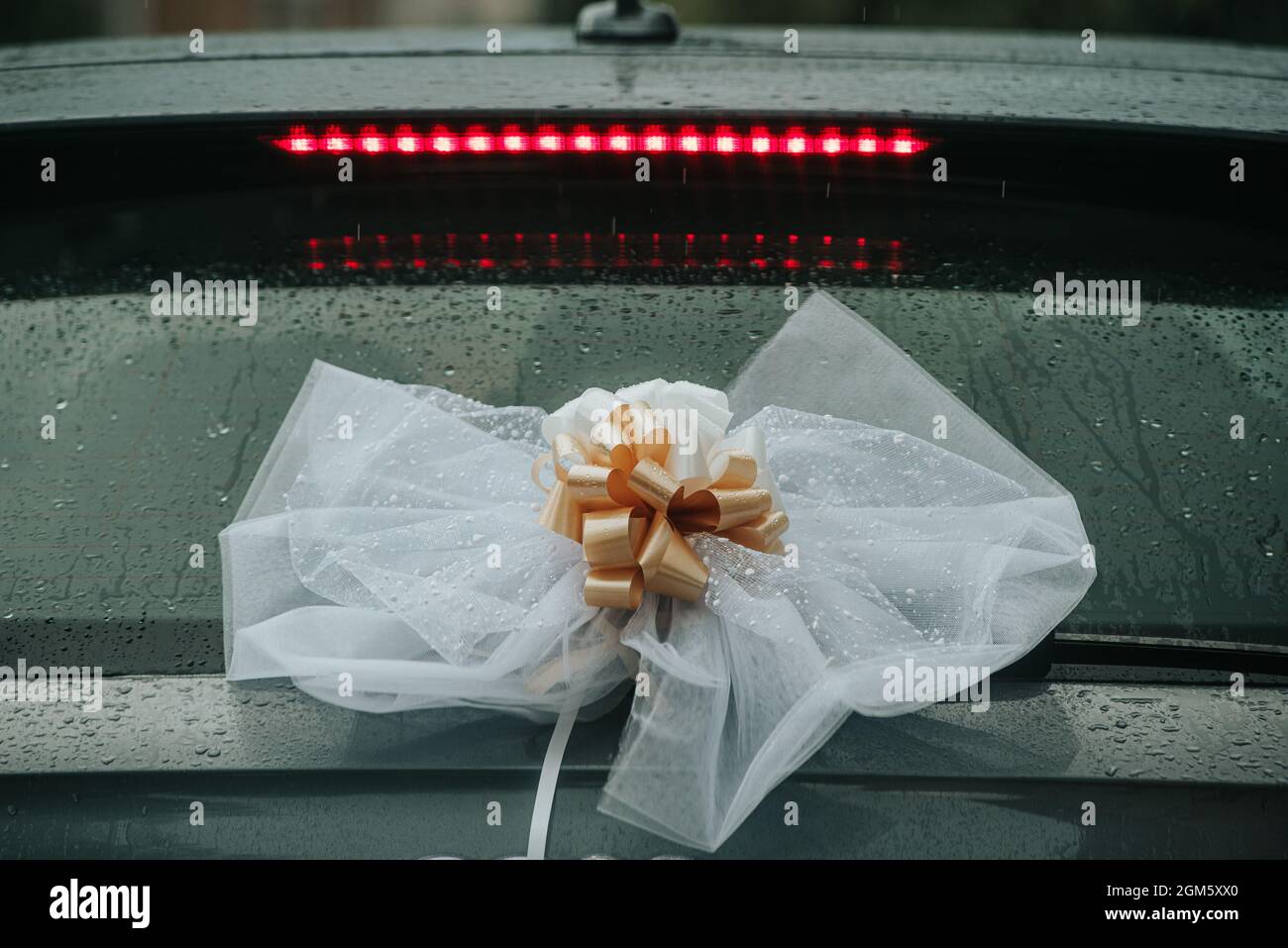 wedding decoration on the back of the car rainy day Stock Photo