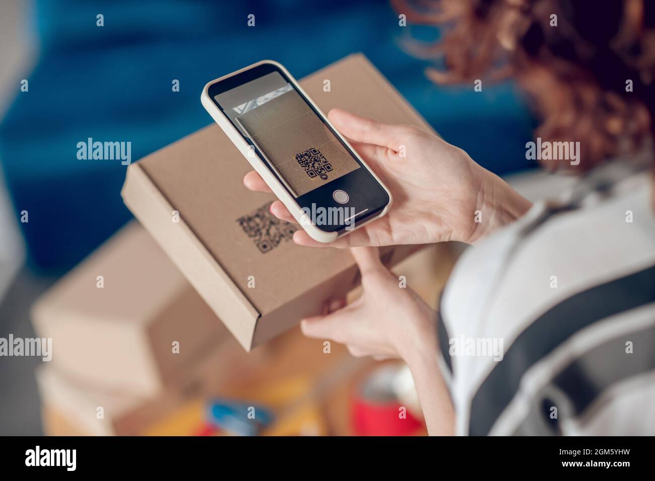 Online shop worker scanning information on the product package Stock Photo