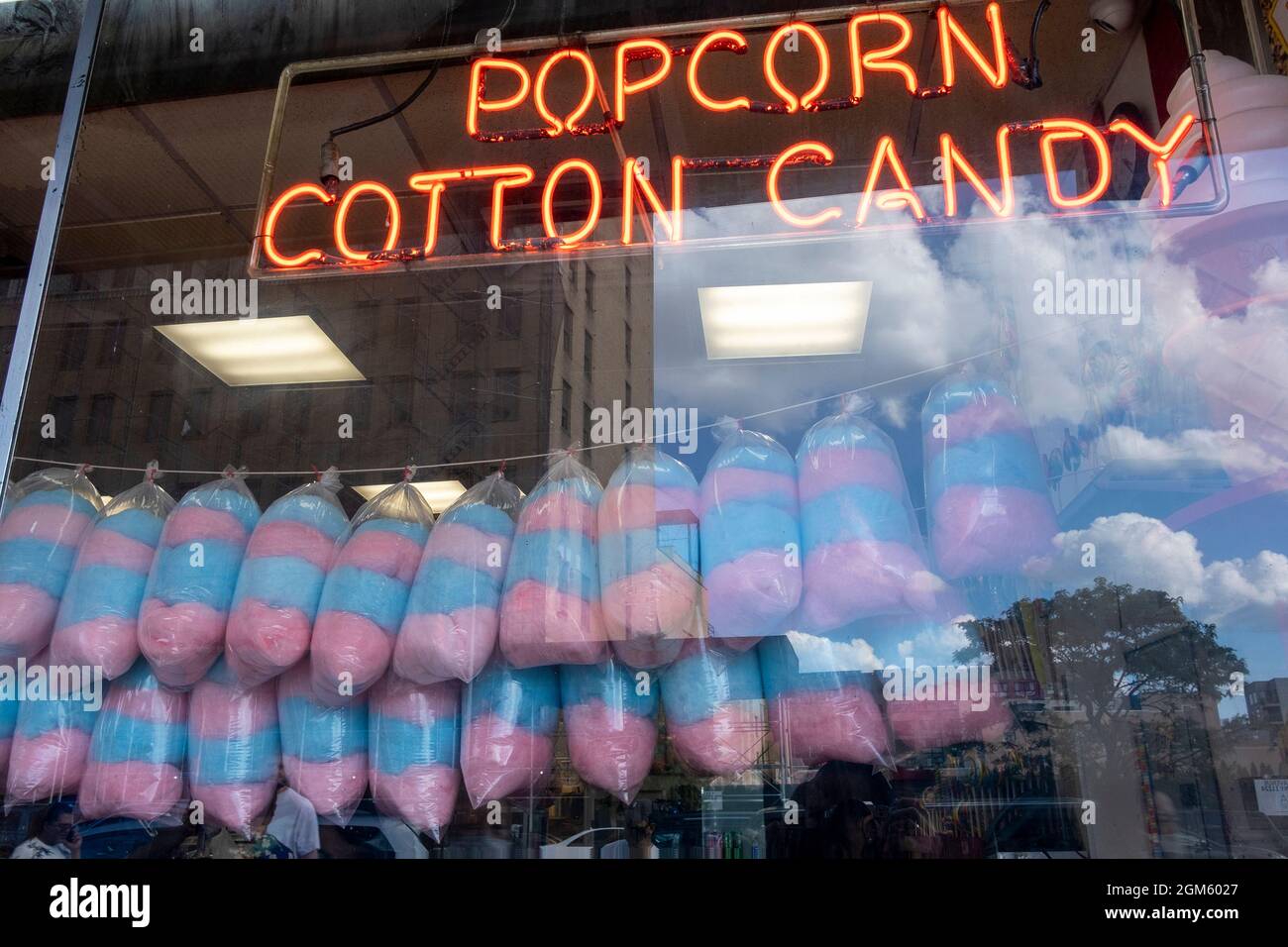 Popcorn and cotton candy sign in window with cotton candy display Stock Photo