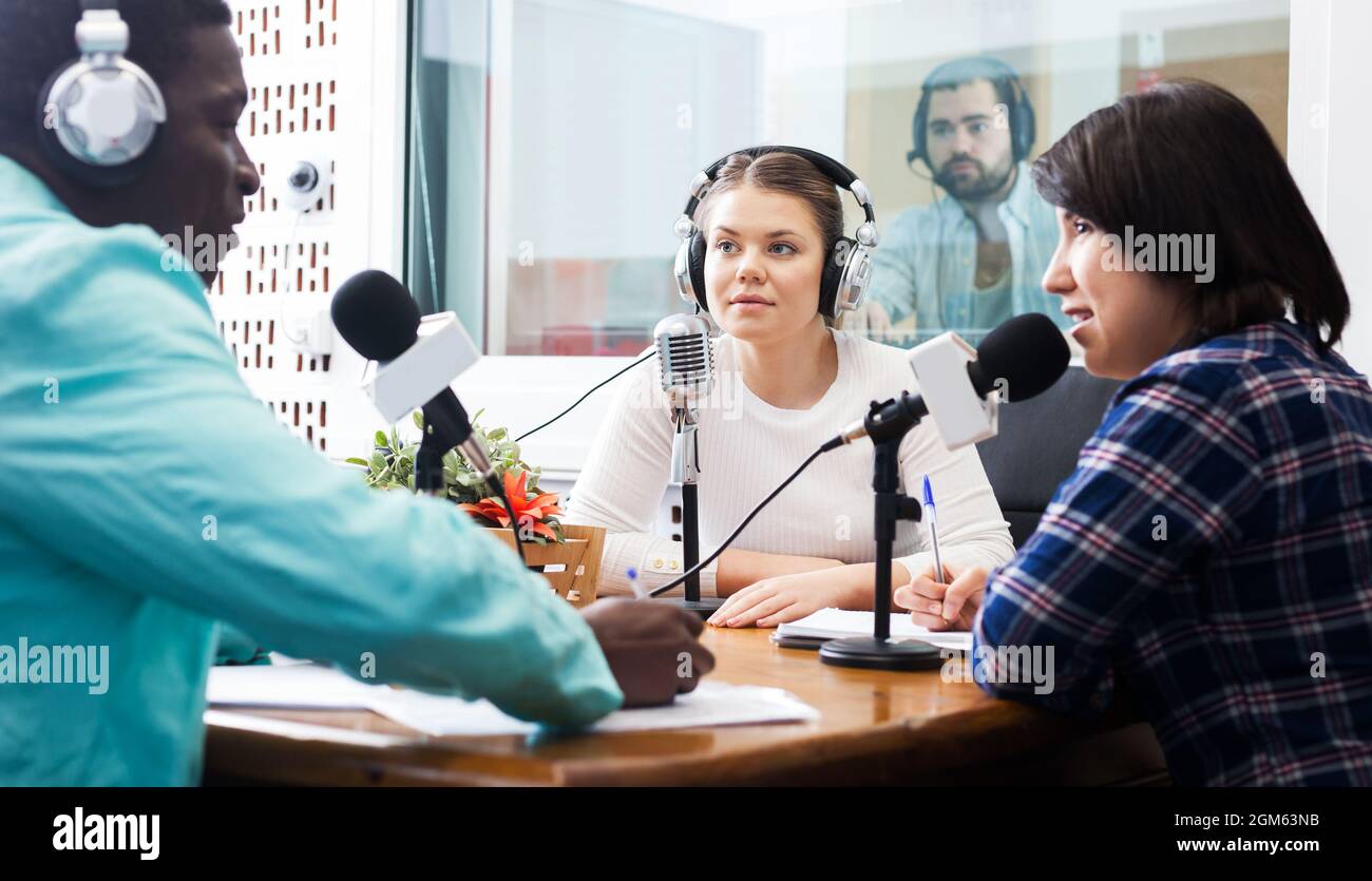Radio hosts interviewing guest Stock Photo Alamy