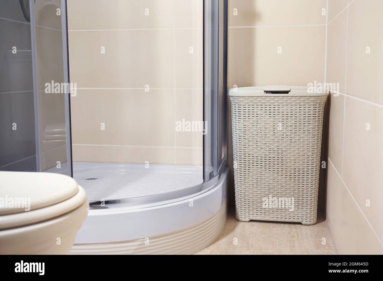 Laundry basket in bathroom Stock Photo Alamy