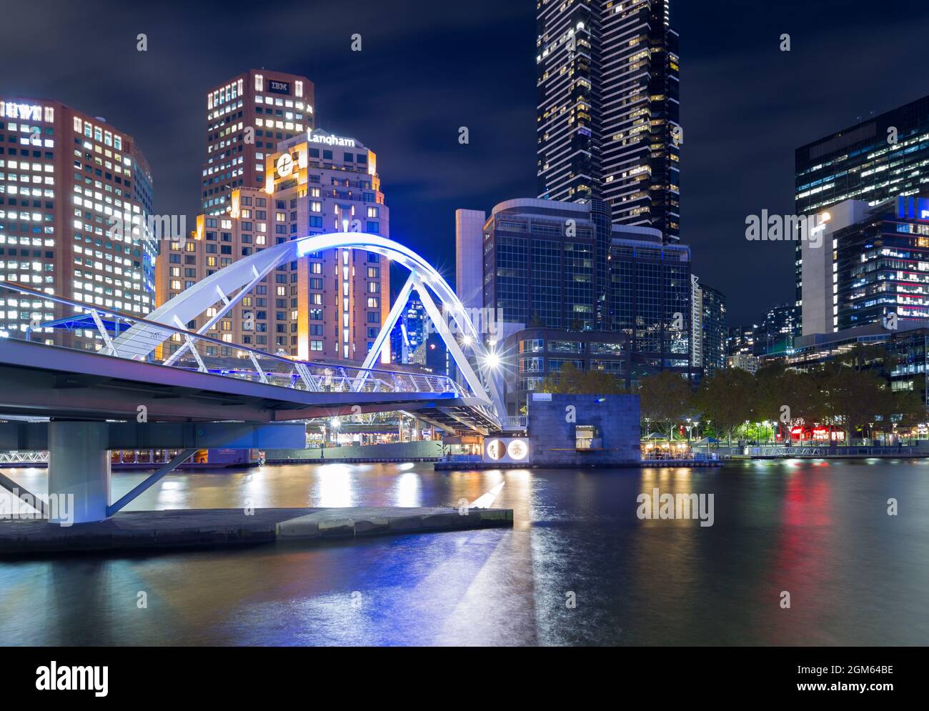 A night view of Melbourne, Australia, seen from the Yarra River at the Evan Walker Bridge, looking towards Southbank highrise buildings. Stock Photo