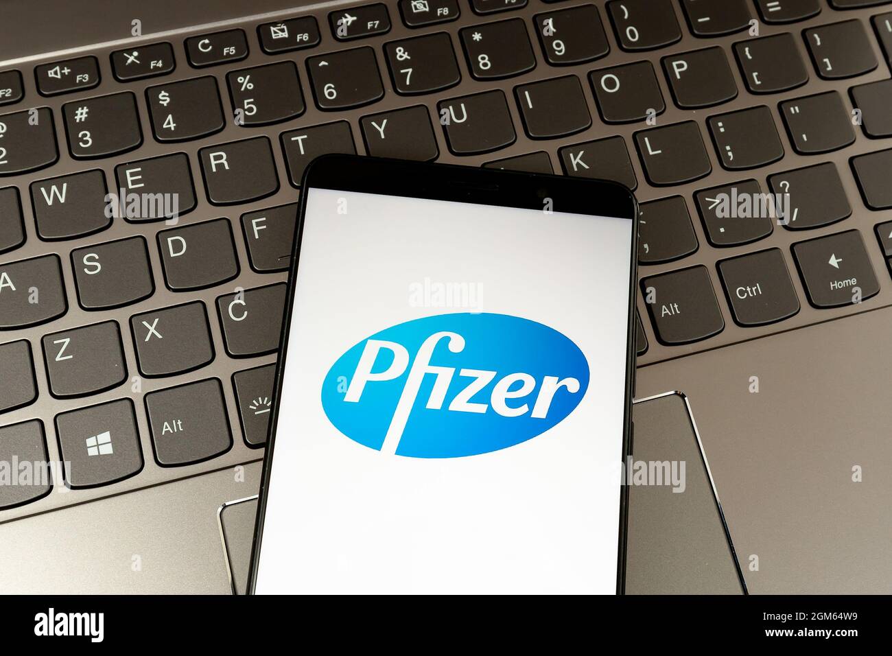 Toronto, Canada - March 18, 2021: Pfizer logo on smartphone screen with keyboard in background. Stock Photo