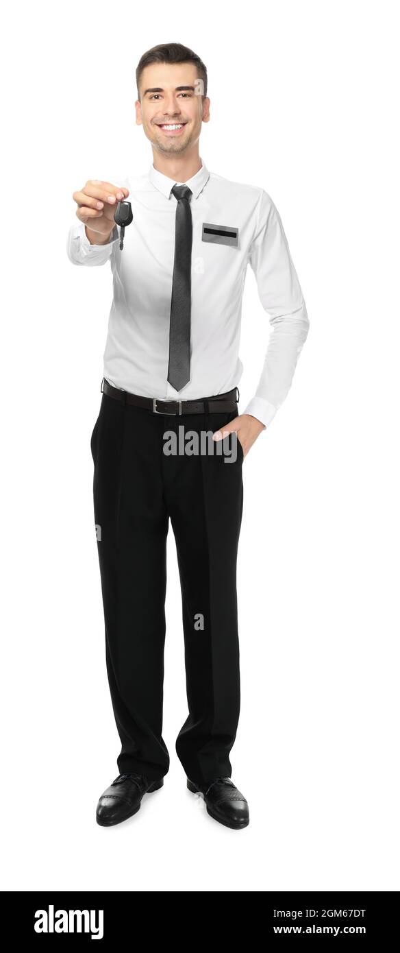 Attractive salesman holding car key on white background Stock Photo - Alamy