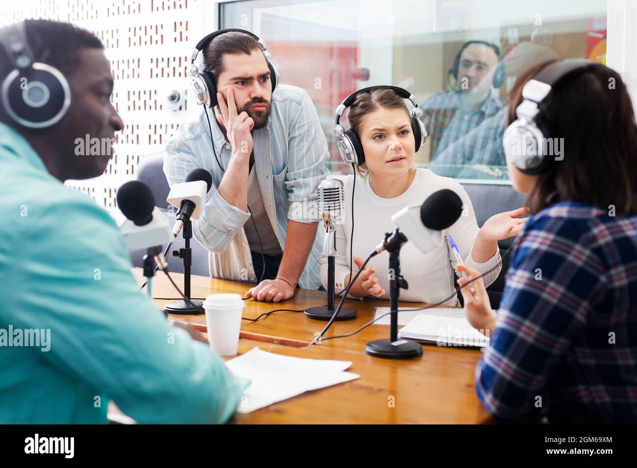 Radio hosts interviewing guest Stock Photo Alamy