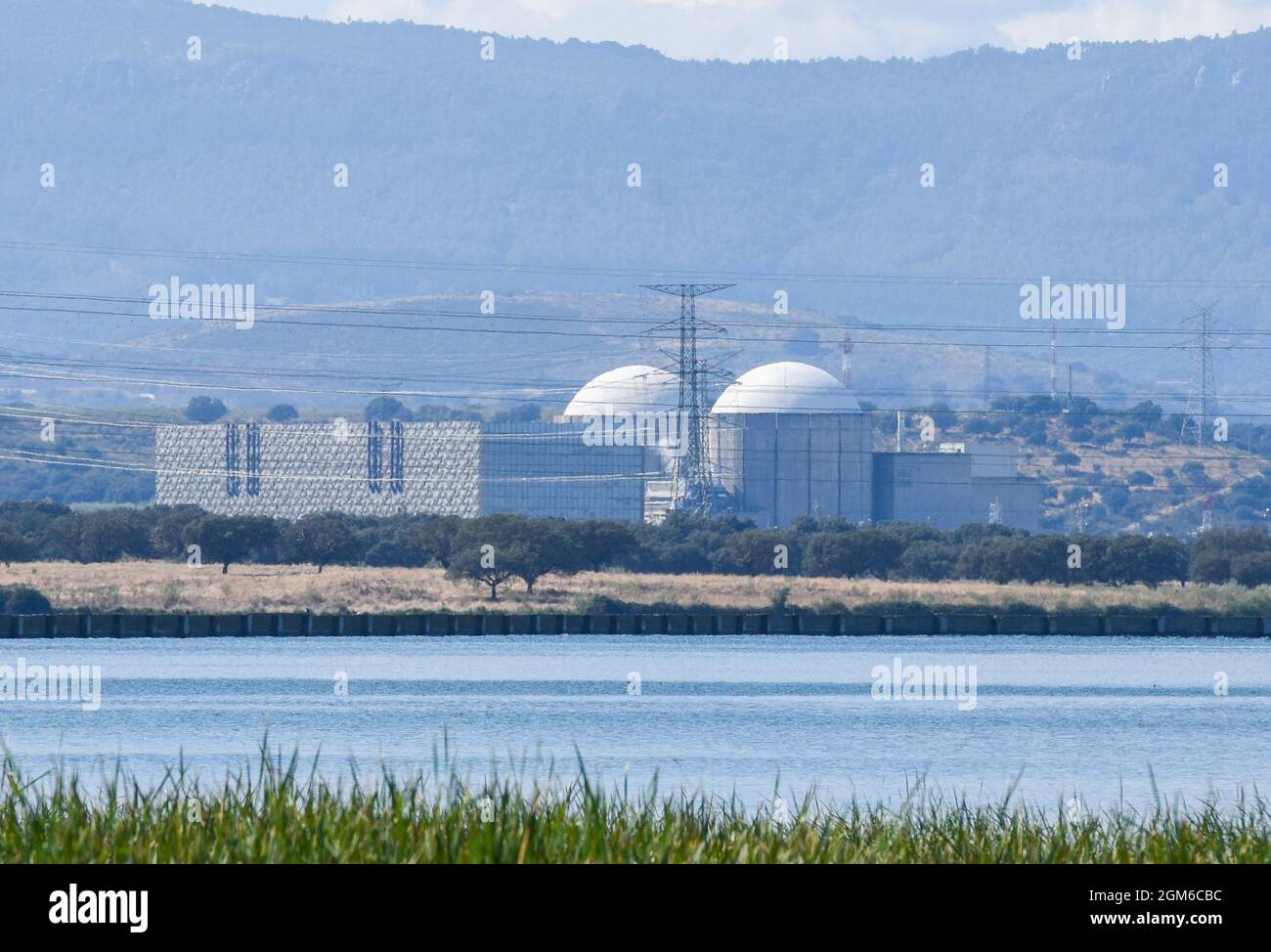 View of the Nuclear Power Plant of Almaraz in Caceres. Property of Iberdrola Generación Nuclear, S.A.U. (53%), Endesa Generación, S.A.U (36%) and Gas Natural Fenosa Generación, S.L.U. (11%), this is one of the nuclear power plants that could close because the generation of electricity could not be profitable for the owners with the Government measures. Spanish Government has targeted €2.6bn in “excess profits” from utilities that do not use gas but have benefited anyway from the way rising gas prices have driven electricity prices higher. However, Spain's nuclear power association said the ne Stock Photo