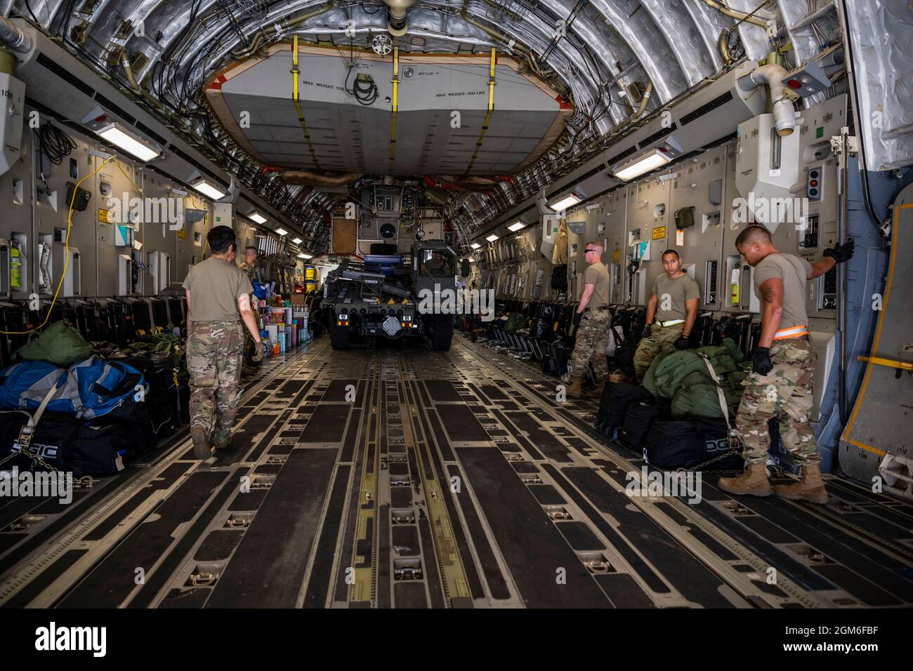 U.S. Airmen from the 60th Aerial Port Squadron ramp services load a K loader on to a C-17 Globemaster III from McChord Air Force Base, Washington, Aug. 25, 2021, on the flight line at Travis AFB, California. The McChord C-17 stopped while en route to an undisclosed location in support of Operation Allies Refuge to pick up Airmen and equipment from the 860th and 660th AMXS. The two maintenance squadrons maintain the C-17 and KC-10 Extender, respectively. The U.S. Air Force, in support of the Department of Defense, moved forces into theater to facilitate the safe departure and relocation of U.S. Stock Photo