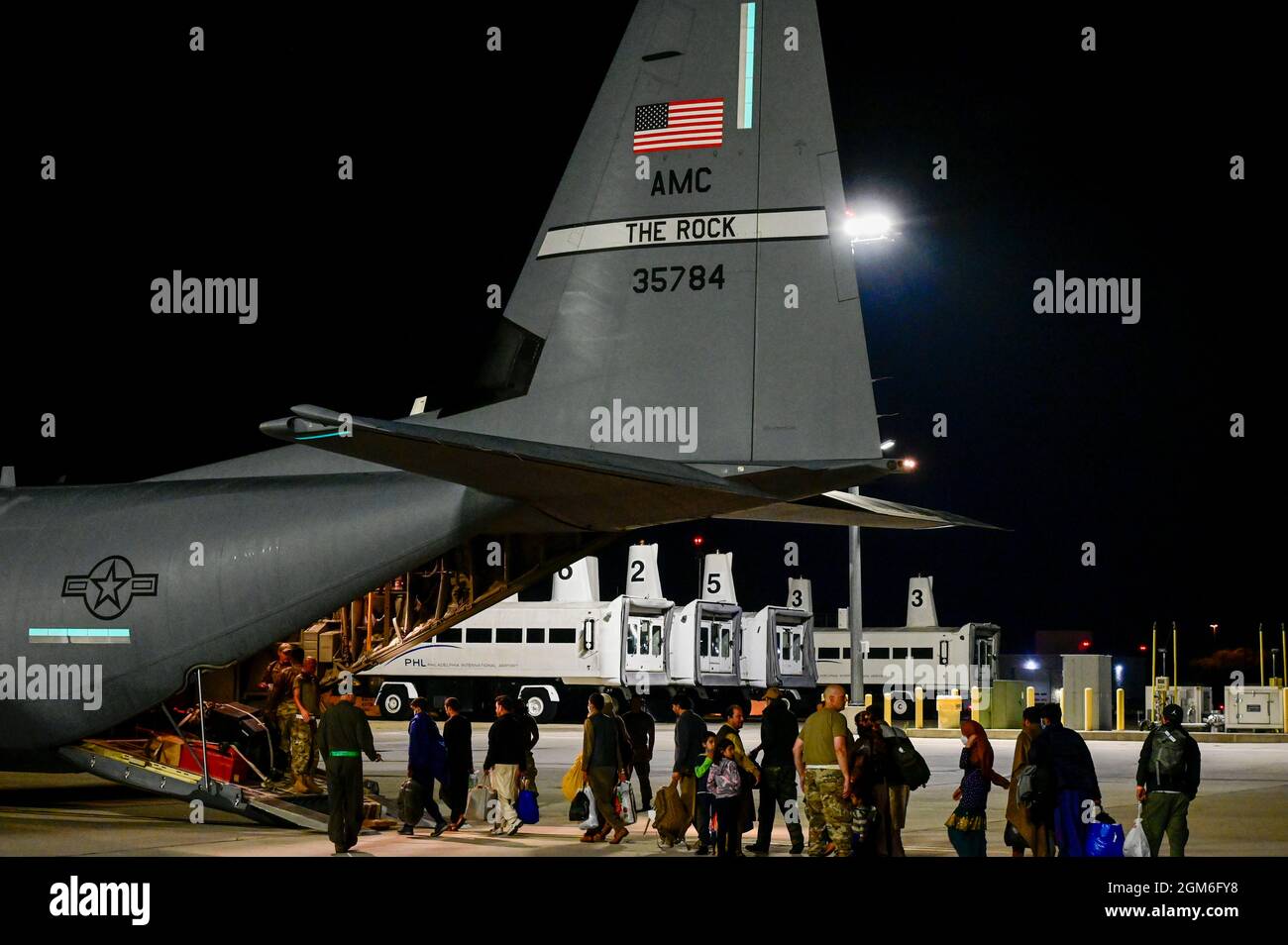 Afghan evacuees board a C-130J Super Hercules assigned to the 19th Airlift Wing at Philadelphia International Airport, Pennsylvania, Aug. 30, 2021, enroute to Fort Bliss, Texas. The Department of Defense, through U.S. Northern Command, and in support of the Department of Homeland Security, is providing transportation, temporary housing, medical screening, and general support for at least 50,000 Afghan evacuees at suitable facilities, in permanent or temporary structures, as quickly as possible. This initiative provides Afghan personnel essential support at secure locations outside Afghanistan. Stock Photo