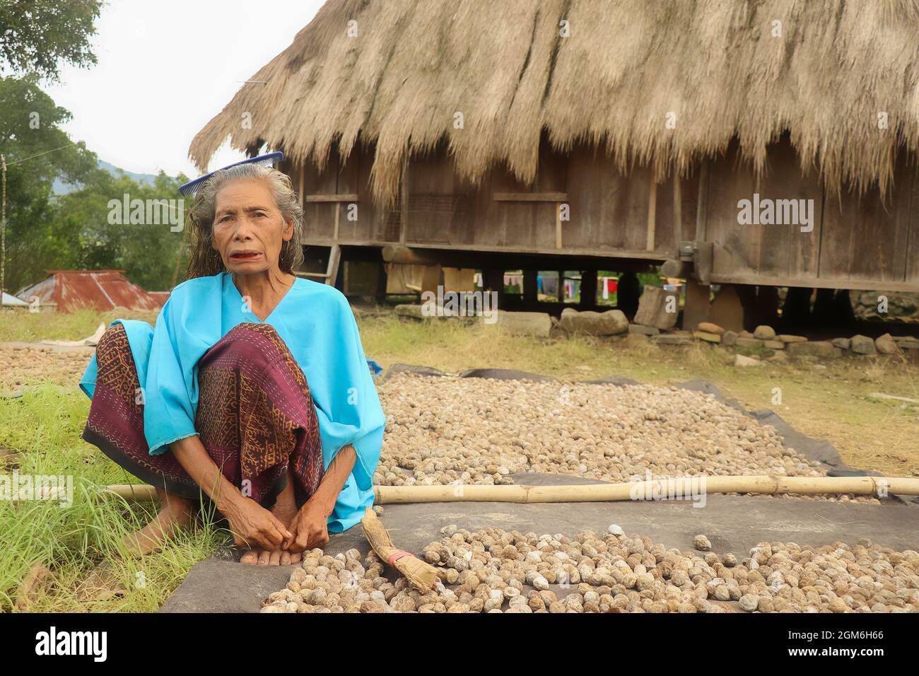 Wologai, Flores, Indonesia, 9 April 2021. Old woman in front of her