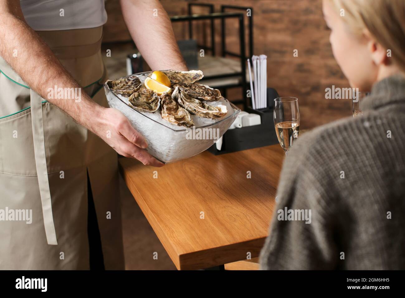 Waiter serving oysters in restaurant Stock Photo Alamy