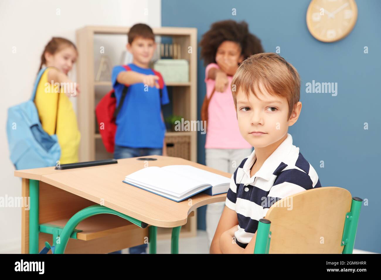 Children Bullying Little Boy In Classroom Stock Photo - Alamy