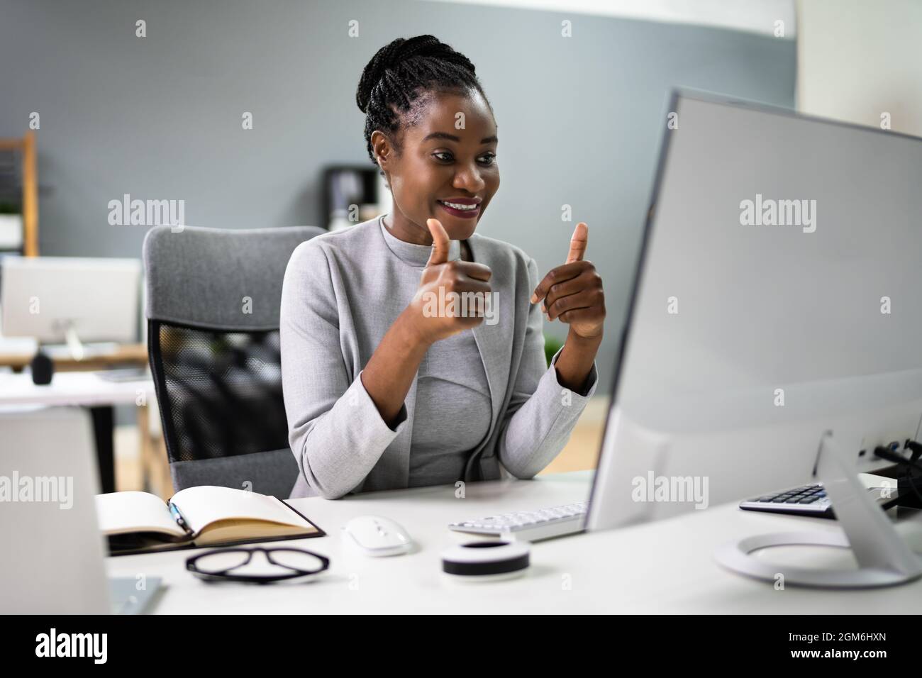 Online Virtual Video Interview Call Showing Thumbs Up Stock Photo