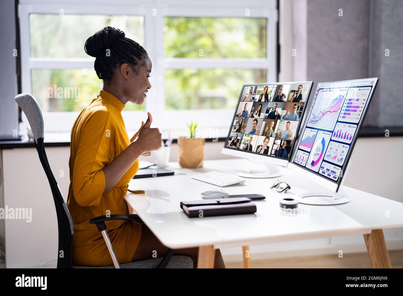Virtual Telework Webinar And Learning Presentation. African Person Telecommute Stock Photo