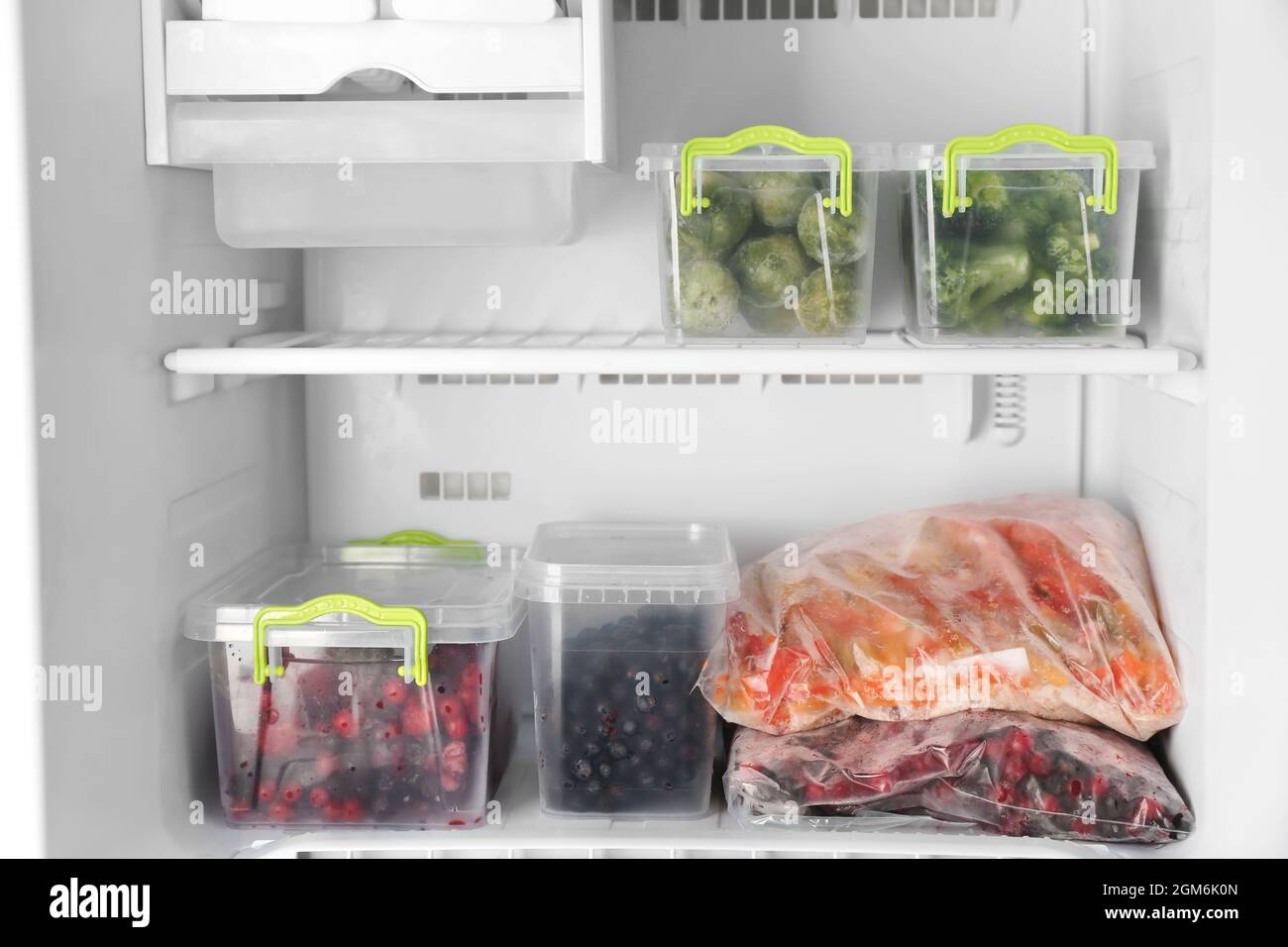 Plastic containers with products in freezer, closeup Stock Photo Alamy