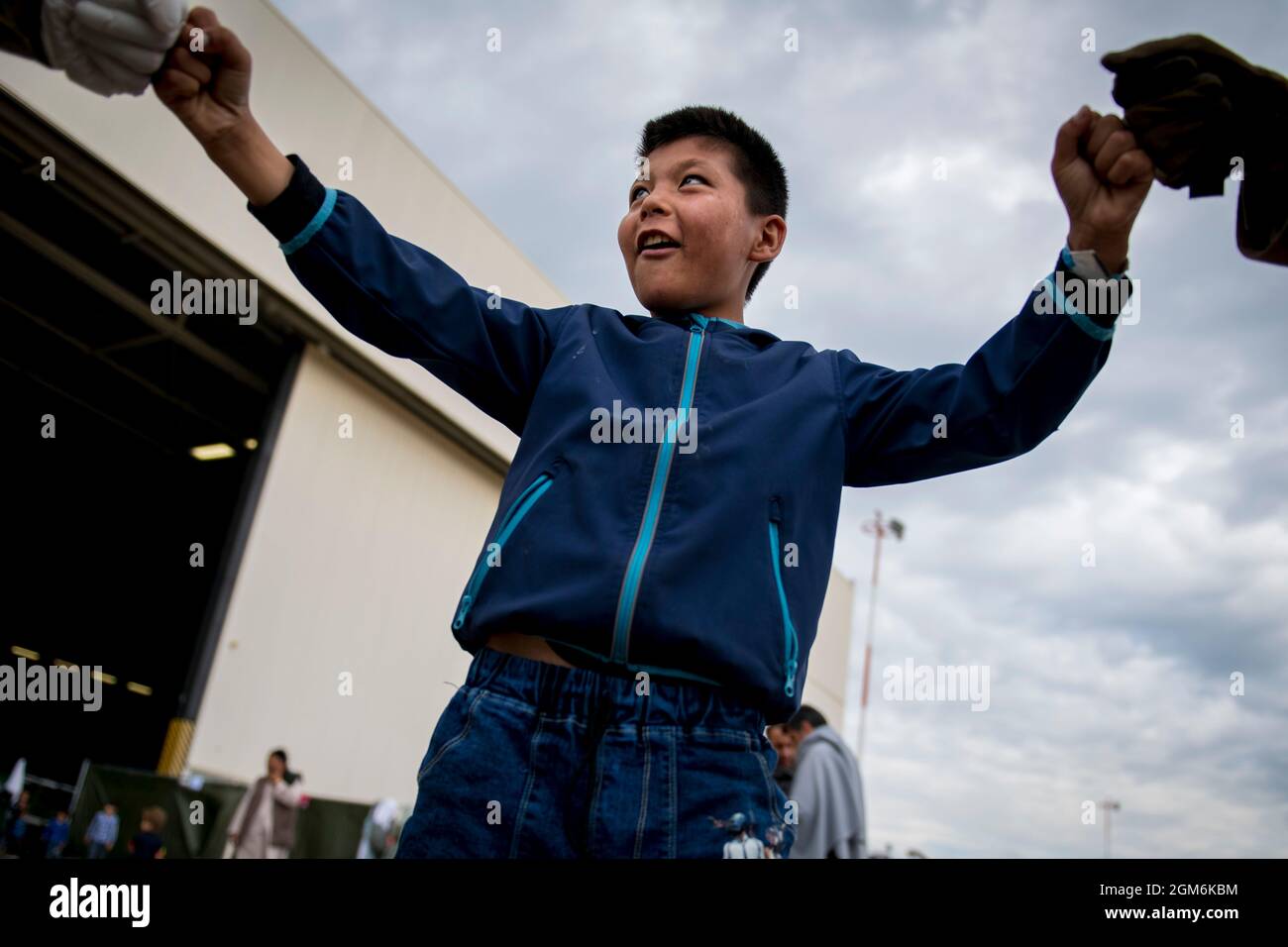 A child from Afghanistan gives two Soldiers assigned to the 1st