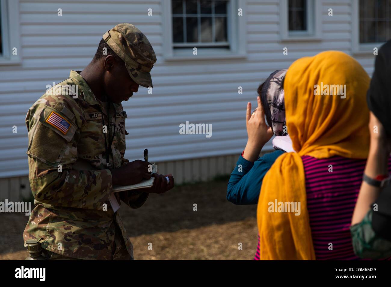 U.S. Army Pfc. Kimani Wiley, a Soldier assigned to 1st Battalion, 506th Infantry Regiment, tallies how many Afghan personnel have received donations during Operation Allies Welcome at Fort Pickett, Virginia, Sep. 12, 2021.  The Department of Defense, through U.S. Northern Command, and in support of the Department of Homeland Security, is providing transportation, temporary housing, medical screening, and general support for at least 50,000 Afghan evacuees at suitable facilities, in permanent or temporary structures, as quickly as possible. This initiative provides Afghan personnel essential su Stock Photo