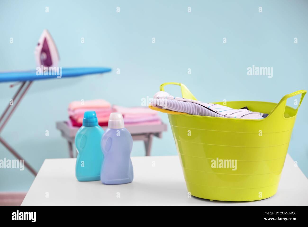Plastic laundry basket with clothes indoors Stock Photo Alamy