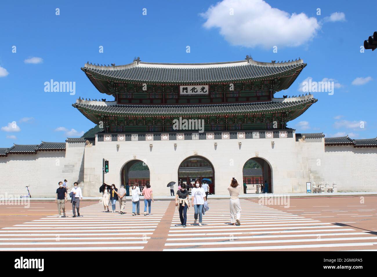 People crossing street in front of Gyeongbokgung Palace, in Gwanghwamun, Seoul, Korea Stock Photo
