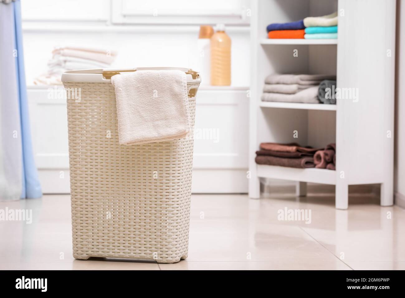 Plastic laundry basket with towel indoors Stock Photo Alamy