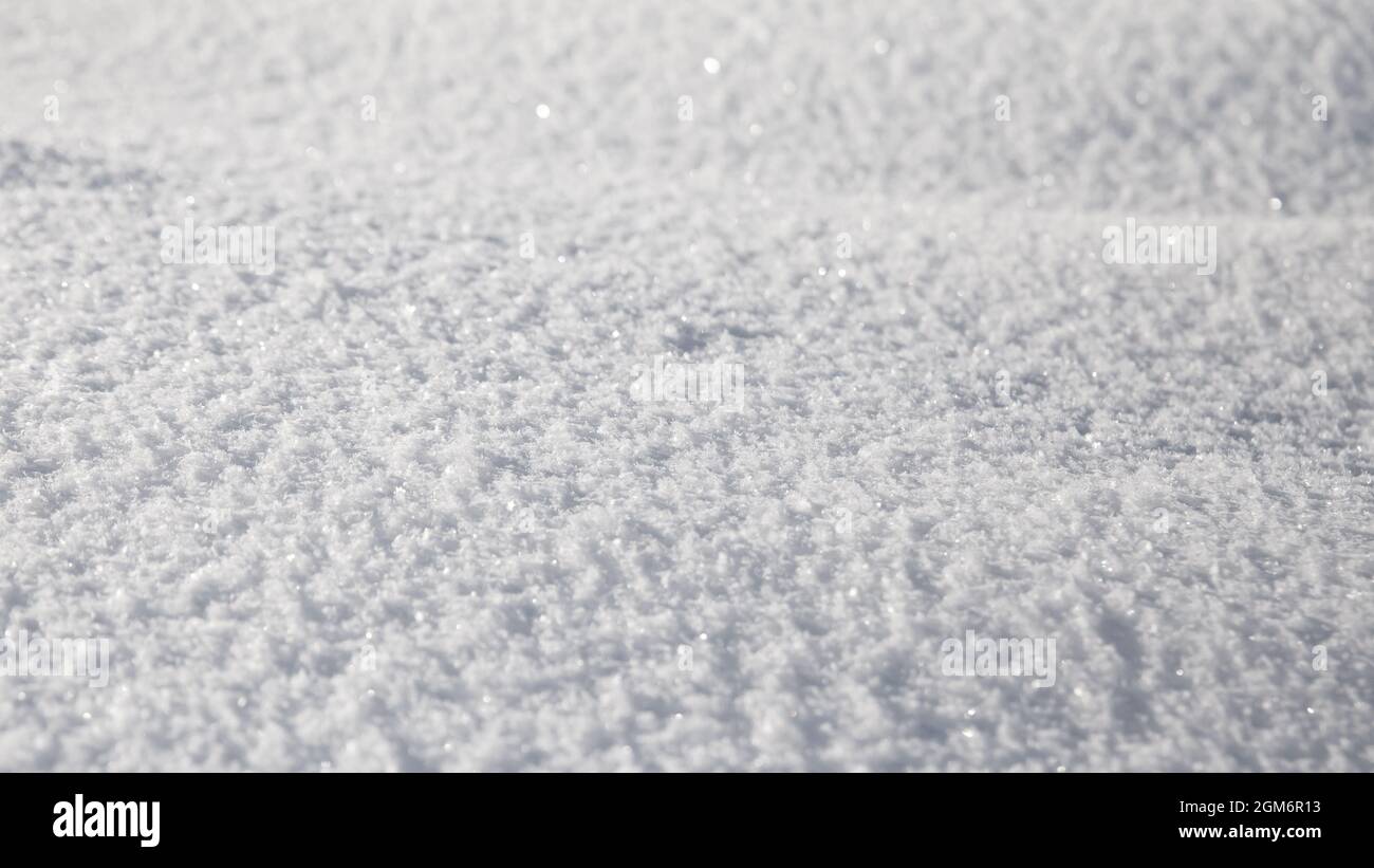 Smooth surface of clean fresh snow. Snowy ground. Winter background with snow patterns. Closeup top view. Wide panoramic texture for background and de Stock Photo