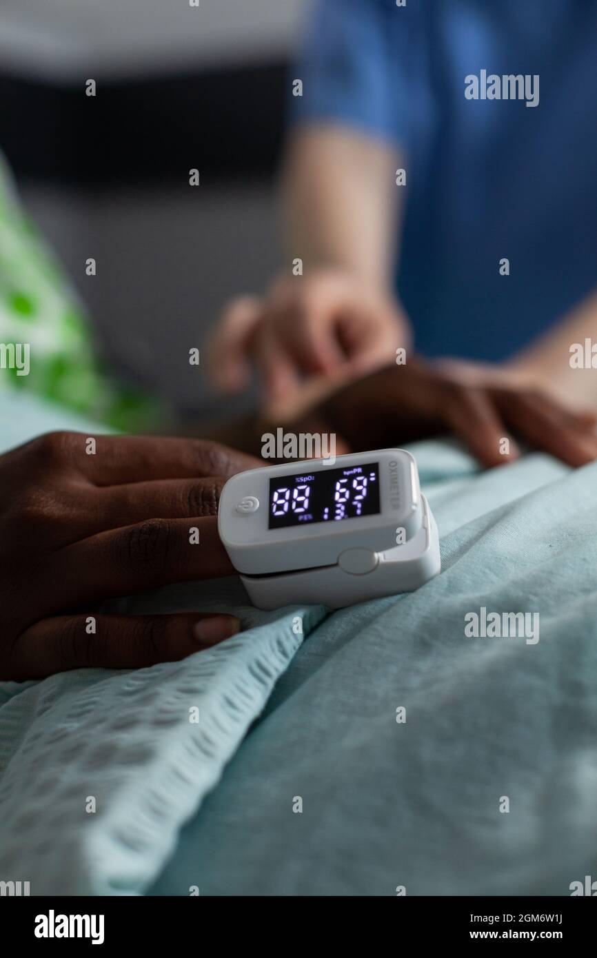 Low O2 Monitor Hospital Close up of oximeter on african american girl hand laying in hospital ...