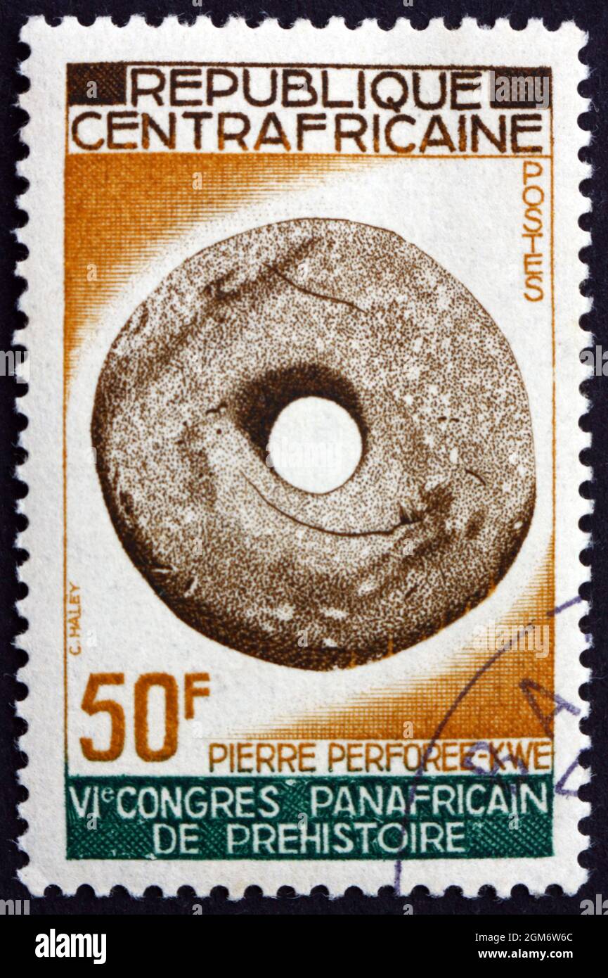 CENTRAL AFRICAN REPUBLIC - CIRCA 1967: a stamp printed in Central African Republic shows Pierced stone, Kwe tribe, circa 1967 Stock Photo