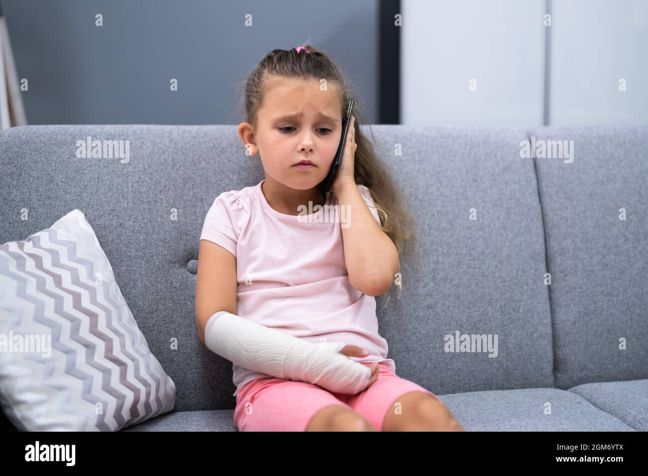 Arm Fracture And Cast. Injured Young Child Recovery Pain Stock Photo
