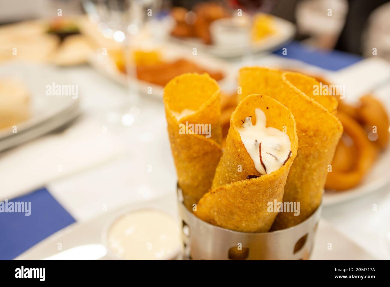 Rolled dorado tacos stuffed with cheese with corn tortillas on