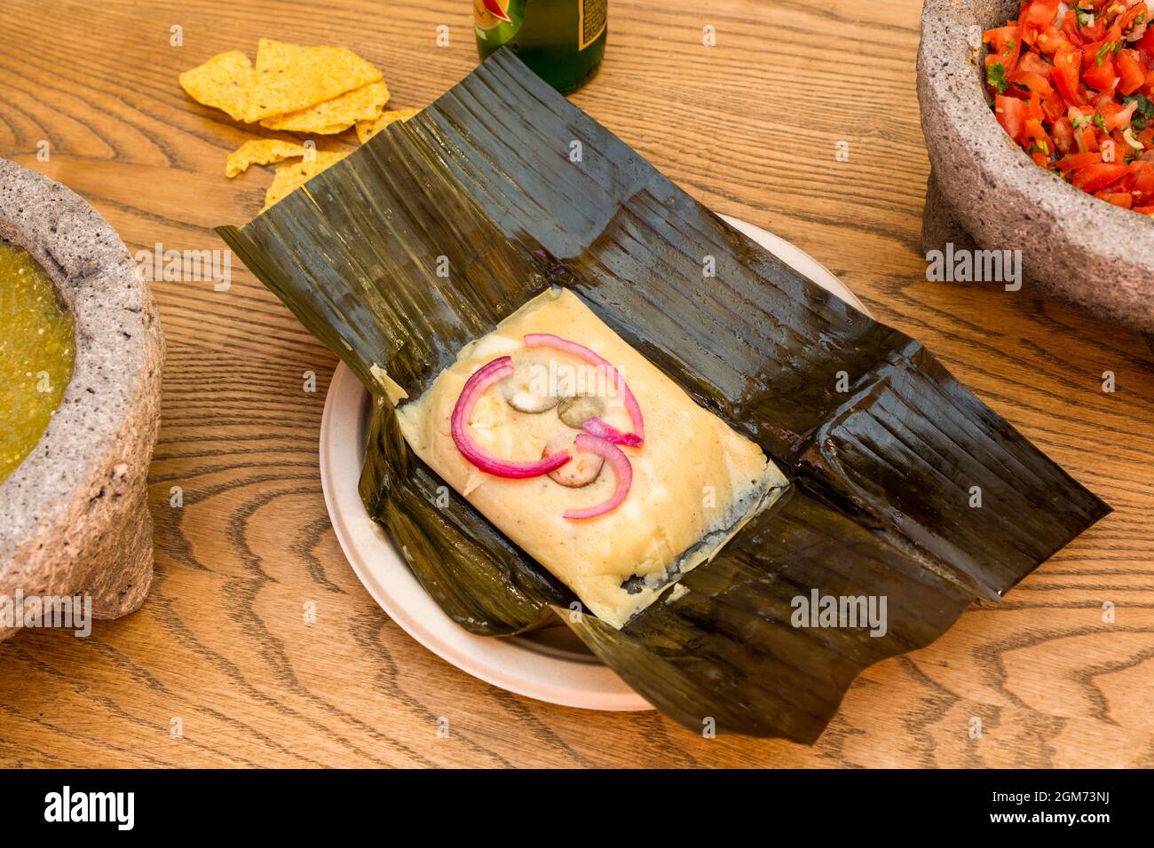 Mexican tamale with recipe for cochinita pibil on folded banana leaf