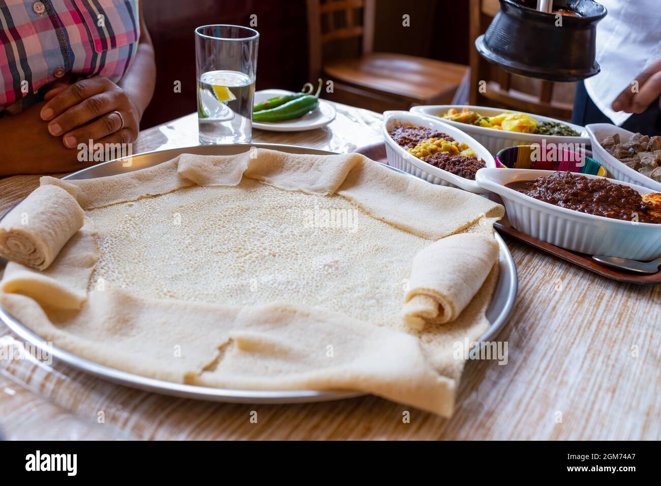 Traditional vegetarian injera meal, with shiro, lentils, egg and a variety of vegetables Stock Photo
