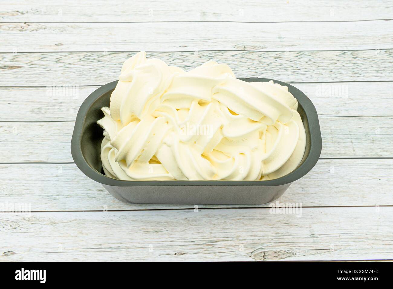 Half-liter tub of vanilla-flavored ice cream in a take away container Stock Photo